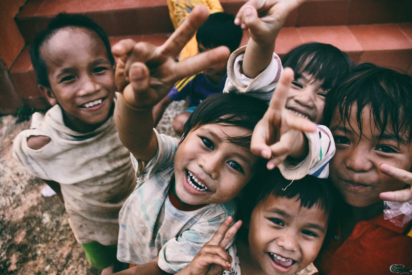 Two smiling children representing hope and community impact